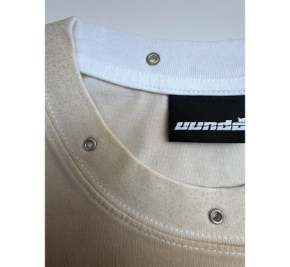 Close-up of a beige and white t-shirt with a white collar and 'uundo' brand label.