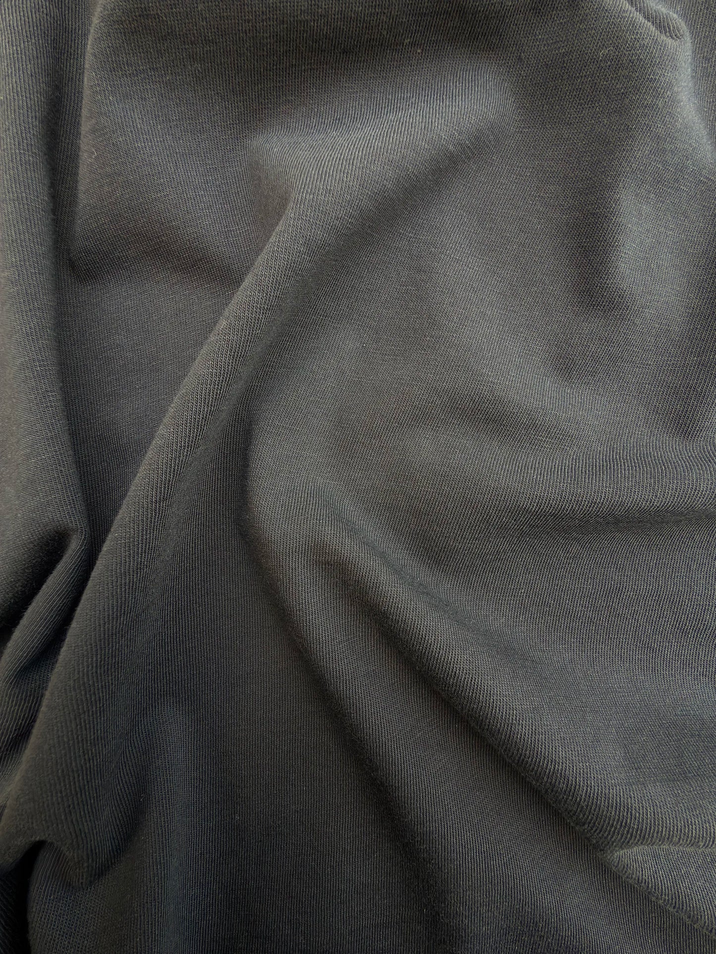 Close-up of dark gray fabric with folds