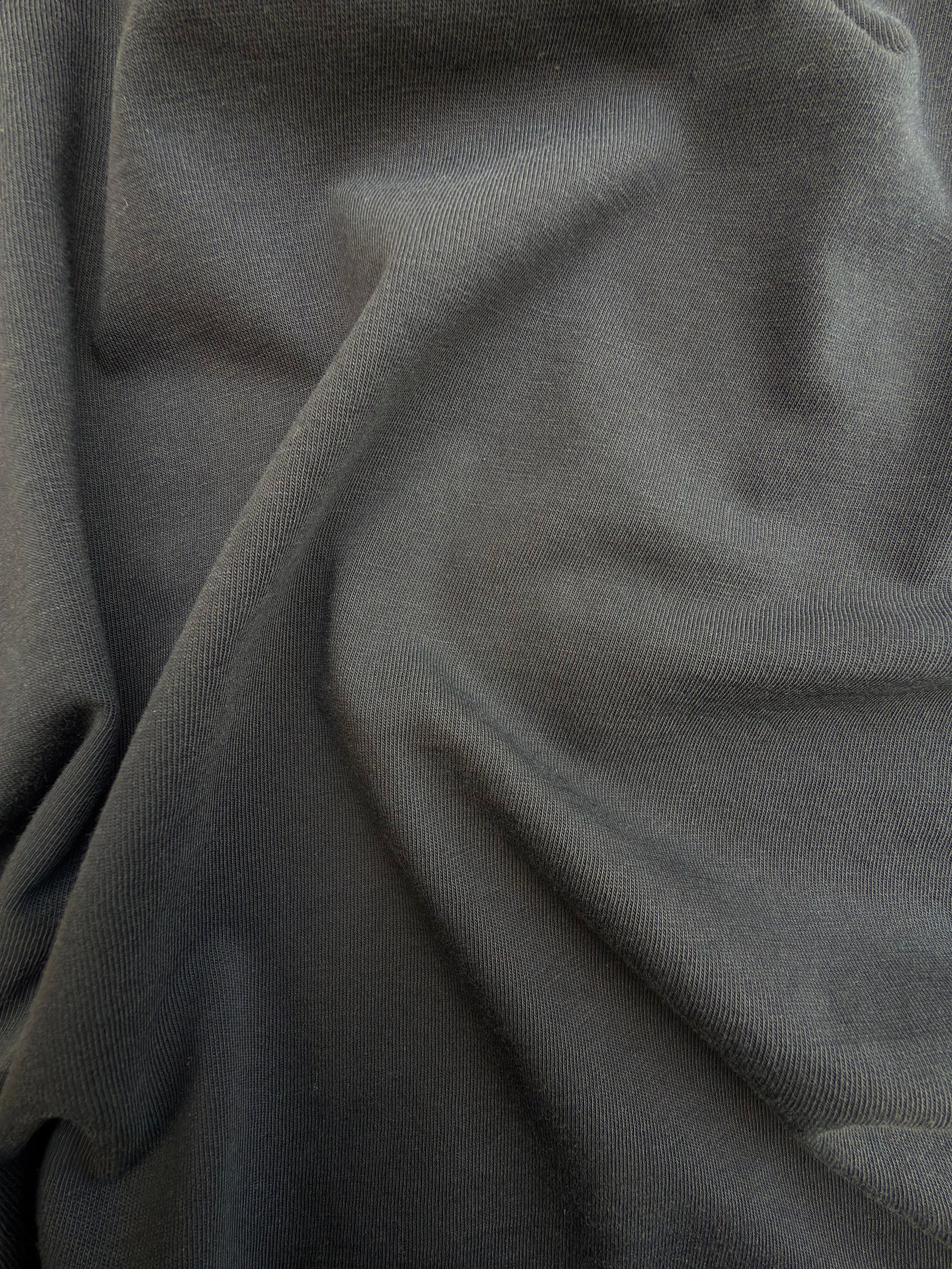 Close-up of dark gray fabric with folds